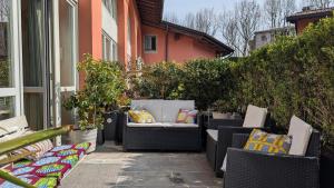 a patio with chairs and pillows on a house at La Corte Di Dafne in Bergamo