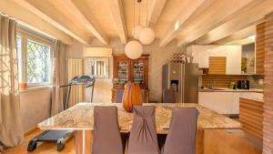 a kitchen with a dining room table and chairs at La Corte Di Dafne in Bergamo