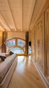 a bedroom with a bed and a large window at La Corte Di Dafne in Bergamo