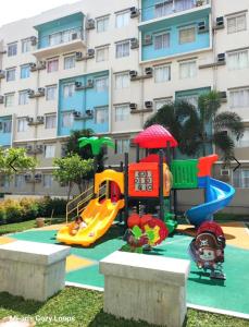 a playground in front of a apartment building at Bayview Haven Studio at Marina Spatial Condominium in Piapi