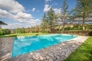 a swimming pool in the yard of a house at Glicine ad Antico Casale '700 in Umbertide
