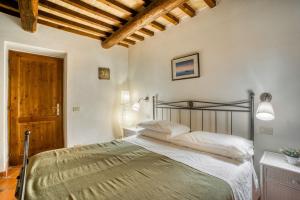 a bedroom with a bed and a wooden ceiling at Glicine ad Antico Casale '700 in Umbertide +18 photos