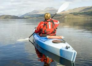 a person in a kayak on a lake at Ardlui Holiday Park in Arrochar
