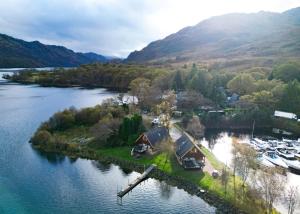 an aerial view of a house on an island in a river at Ardlui Holiday Park in Arrochar