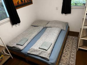 a bed in a room with two pillows on it at Chatička u Perniců in Jedovnice