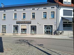a white building on the side of a street at Pension Hösl in Mitterteich