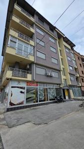 a tall building with a lot of windows at Struga Alpha House in Struga