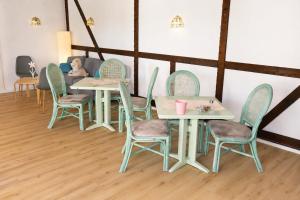 a group of tables and chairs in a room at Möwennest Zempin in Zempin