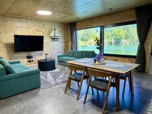 a living room with a table and a tv at Sunset hausbot in Bratislava