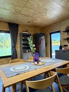 a dining room with a table and chairs and a kitchen at Sunset hausbot in Bratislava