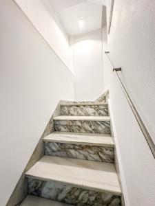 a staircase in a building with stone steps at Casa das Faluchas by ALÔGA in Finisterre