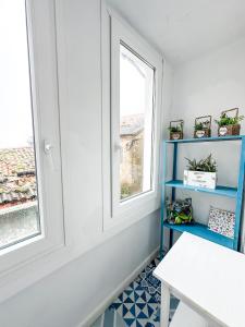 a room with a blue shelf and a window at Casa das Faluchas by ALÔGA in Finisterre