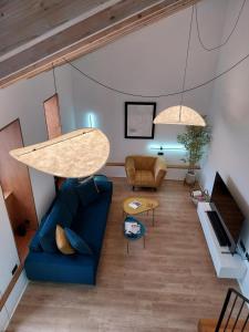 a living room with a blue couch and a table at Casa Gafura in Noya