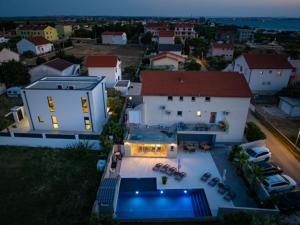 an aerial view of a house with a swimming pool at Apartment Maki with new Pool Nin in Vrsi