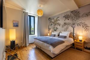 a bedroom with a bed and a large window at Le Domaine Du Clos in Tourmont