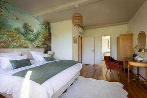 a bedroom with a large bed and a painting on the wall at Le Domaine Du Clos in Tourmont +63 photos