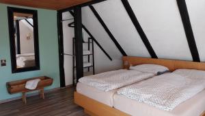 a bedroom with two beds and a mirror at Marienthal in Ingersleben