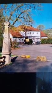 a building with three rocks in front of a road at Marienthal in Ingersleben
