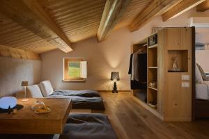 a living room with two beds and a table at Aura Relais in Urbino +104 photos