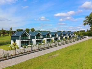 an image of a row of houses on a road at Domki i Apartamenty WiR na Kaszubach in Chmielno