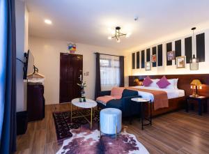 a hotel room with a bed and a couch at UNWND Boutique Hotel Camiguin in Mambajao