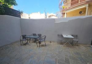 a table and chairs sitting next to a wall at Evripos escape in Chalkida