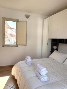 a bedroom with a bed with towels on it at Etna Terrace Casa Lidia in Gaggi