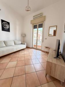 a living room with a couch and a table at Etna Terrace Casa Lidia in Gaggi