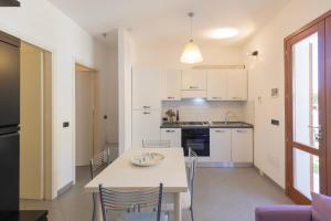 a kitchen and dining room with a table and chairs at Casa Martina by ElbaSummer in Lacona