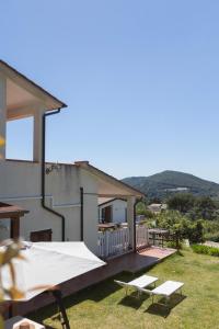a house with a patio with a table and chairs at Casa Martina by ElbaSummer in Lacona