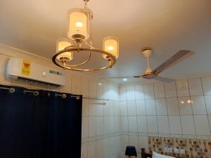 a chandelier in a bathroom with a ceiling at Trapezium Lodge in Amasaman +29 photos