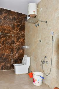 a bathroom with a shower with a toilet and a sink at Zeeenu Abode Yercaud by GD in Yercaud +32 photos