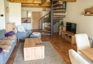 a living room with a couch and a table at Apartmán Říčky 23 in Říčky