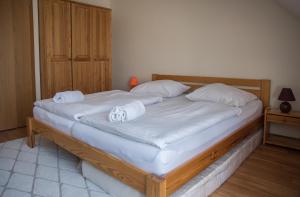 a bedroom with a bed with white sheets and pillows at Apartmán Říčky 23 in Říčky +37 photos
