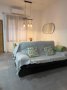 a bedroom with a couch with pillows on it at Loft el Baix - Cullera in Cullera