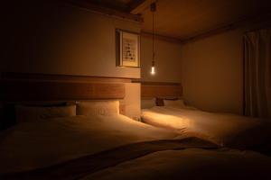 a dark room with two beds in a bedroom at Cellar 88 in Sonogi +42 photos