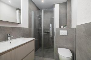 a bathroom with a shower and a toilet and a sink at Seaview apartments Refugium Krk in Polje