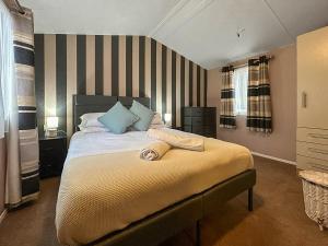 a bedroom with a large bed with blue pillows at The Ash in Angus