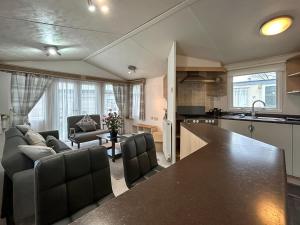 a kitchen and living room with a large counter top at The Ash in Angus