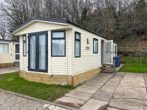 a tiny house is sitting on the side of a driveway at The Ash in Angus