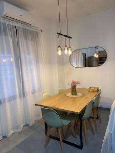 a dining room with a wooden table and chairs at Loft el Baix - Cullera in Cullera +5 photos