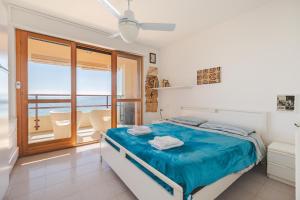 a bedroom with a bed with a view of the ocean at Fronte mare con parcheggio! in Grado +16 photos