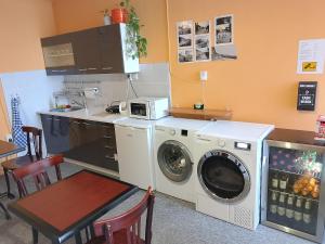 a kitchen with a washing machine and a table at Pension Dobroucky in Prague