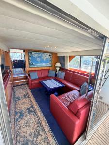 a living room with a red couch and a table at Marina Estensi Floating Resort - Classic Yacht in Lido degli Estensi