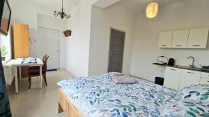 a room with a bed and a kitchen with a table at Bos-Znam Pokoje in Gdynia +24 photos