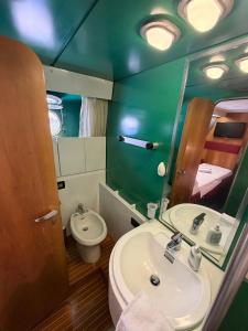 a bathroom with a sink and a toilet and a mirror at Marina Estensi Floating Resort - Classic Yacht in Lido degli Estensi +19 photos