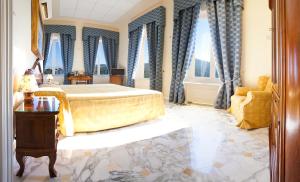 a bedroom with a king sized bed and windows at Villa Angelina in Massa Lubrense
