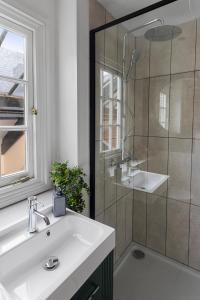 a bathroom with a sink and a shower at The Courtyard in Exeter