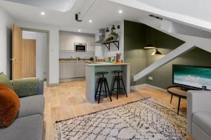 a living room with a couch and a kitchen at The Courtyard in Exeter