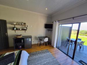 a living room with a table and a dining room at Toekoms Inn in Aliwal North +15 photos